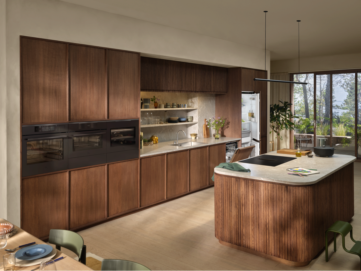 Electrolux kitchen with wood-grain cabinets, marble island and integrated appliances