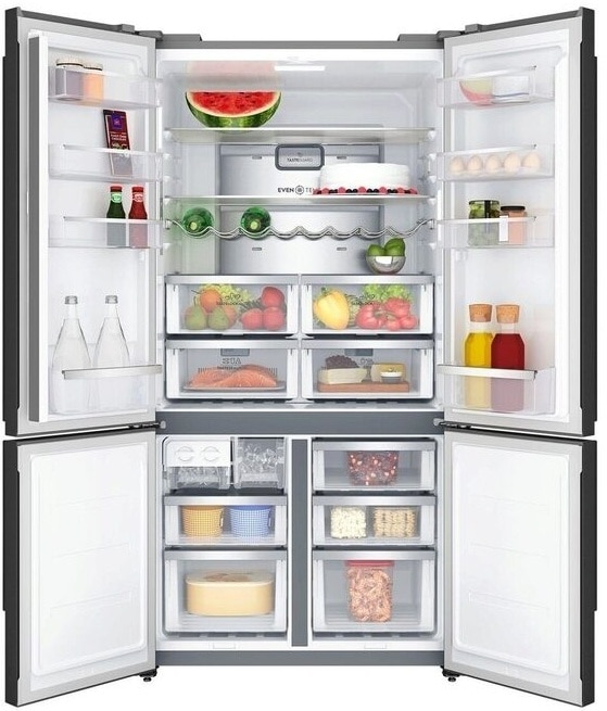 Stocked four-door refrigerator interior with produce and beverages