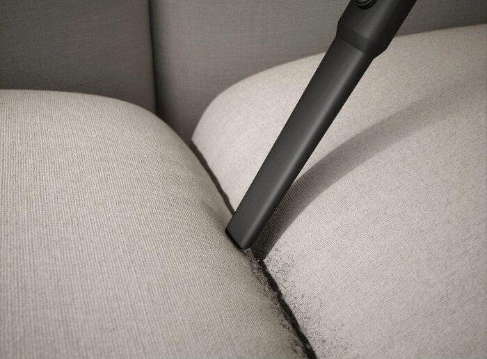 Vacuum crevice attachment cleaning sofa crease