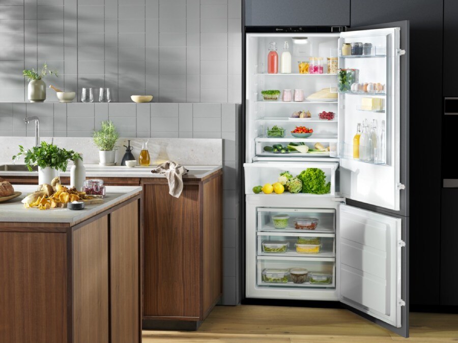 An open, fully stocked Electrolux refrigerator showcasing smart fridge organization tips