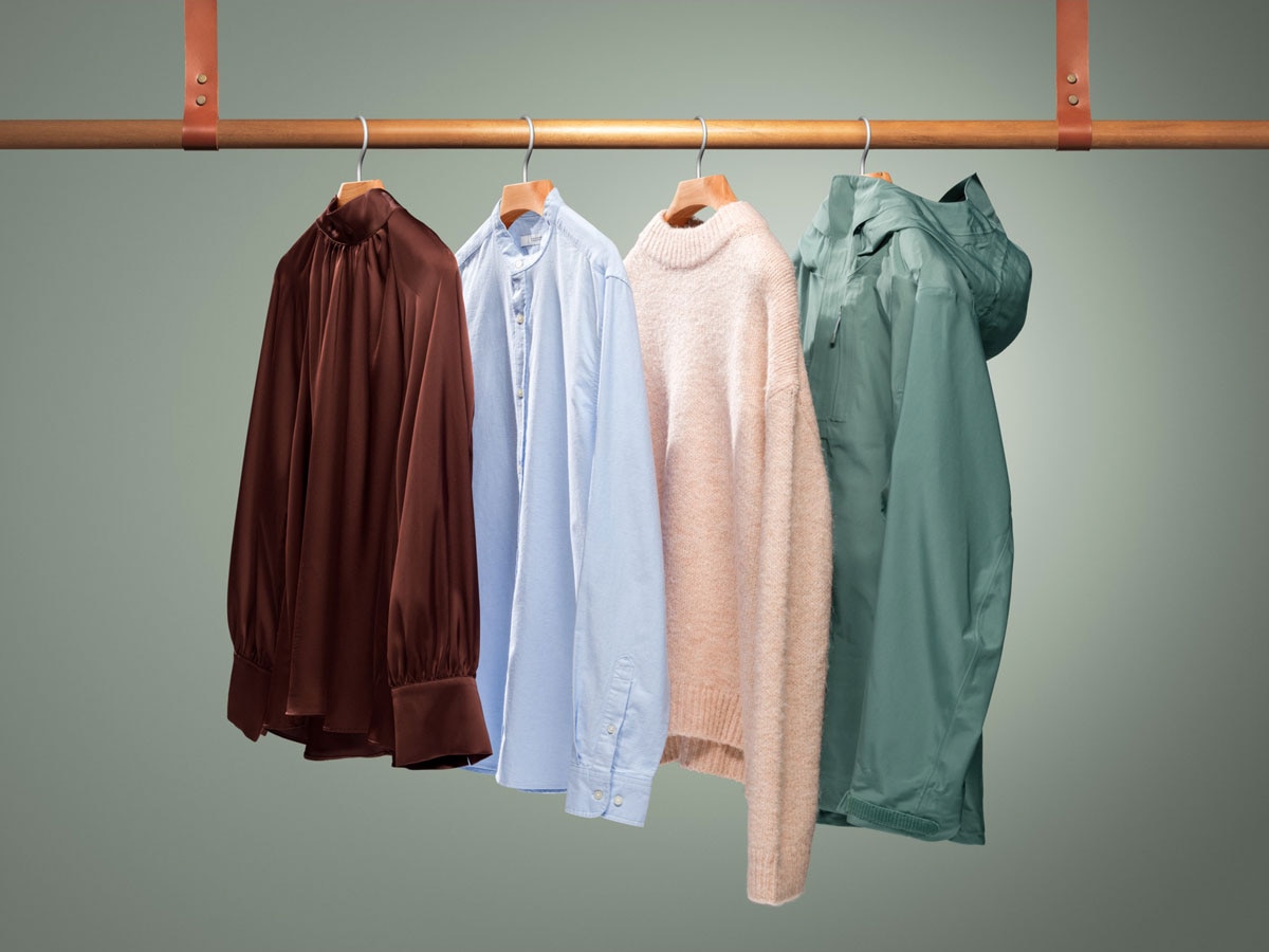 Clothes hanging on wooden bar