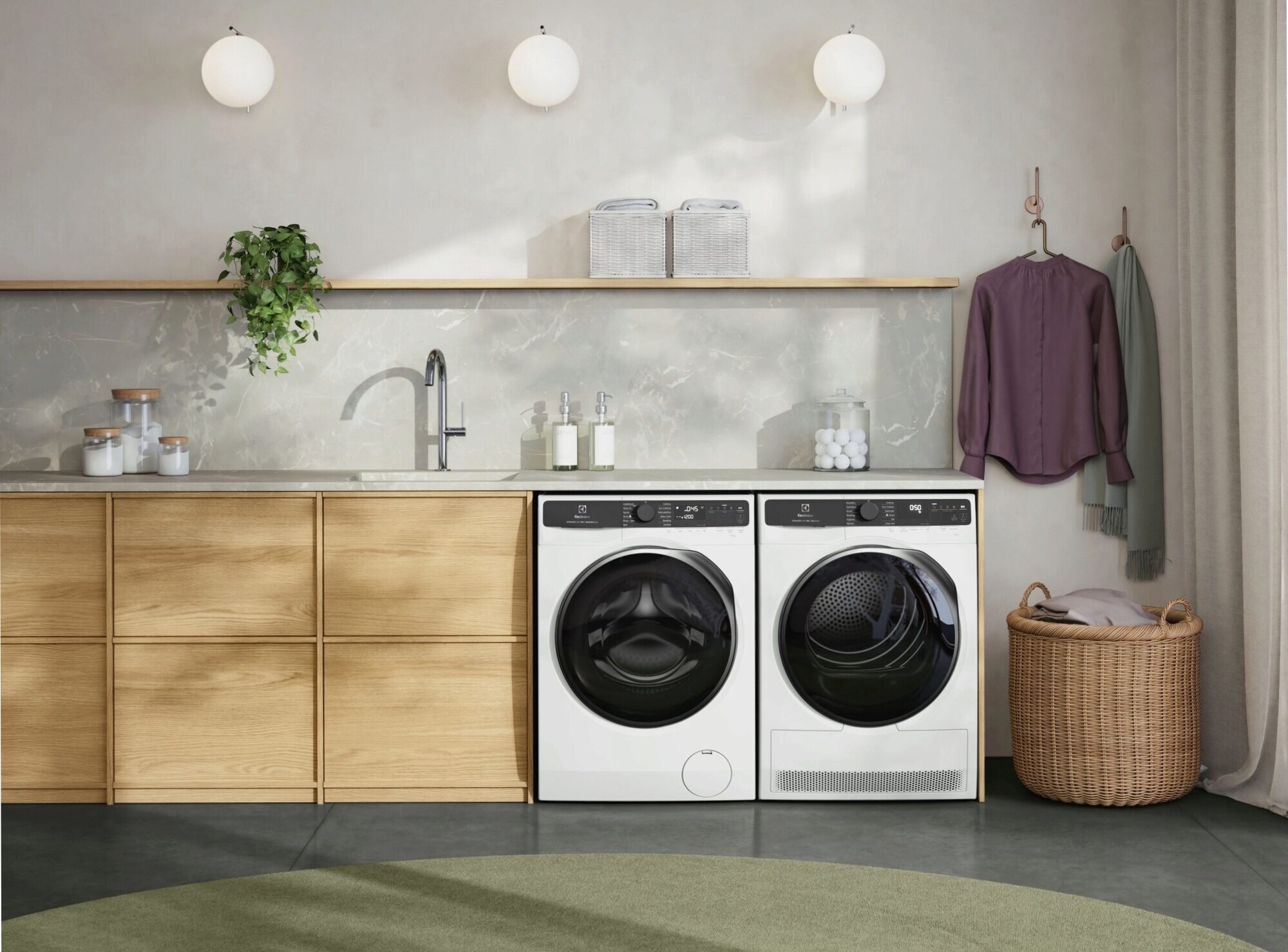 A modern laundry room featuring an Electrolux washing machine and dryer