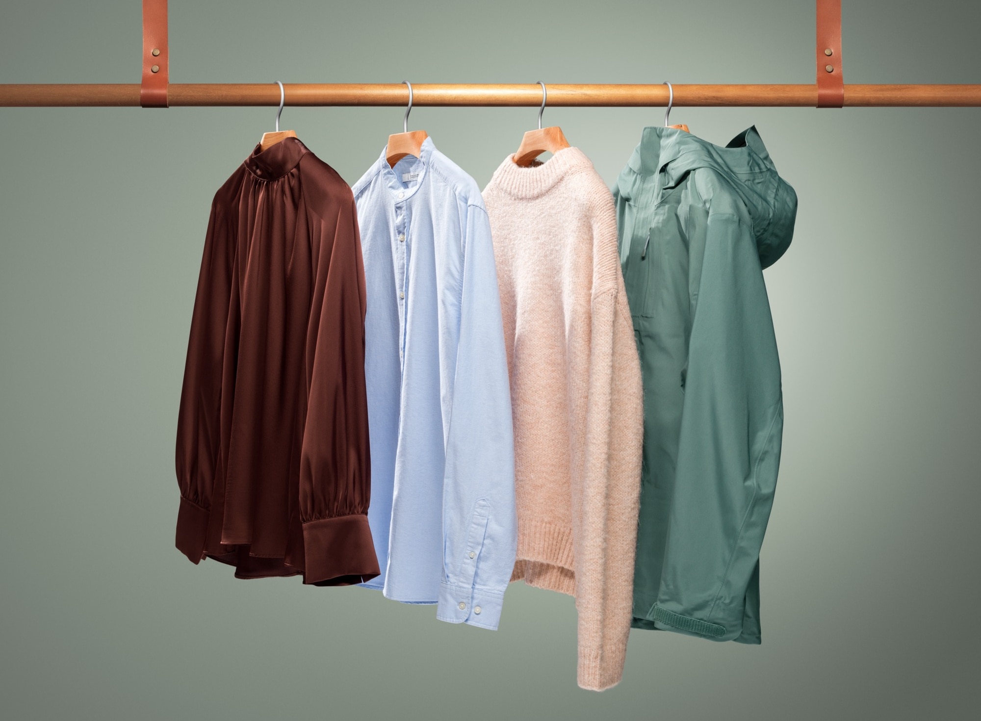 Freshly washed clothes hanging on a wooden drying rod