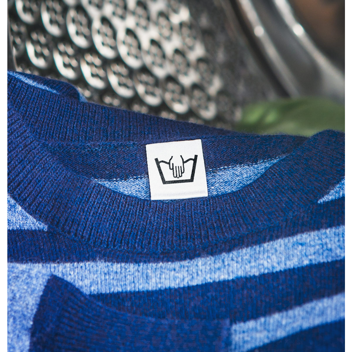 Wool sweater label showing hand wash symbol