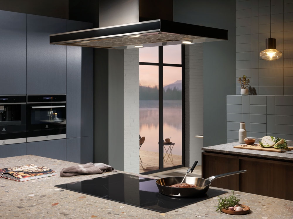 Modern cooking bundle with Electrolux induction cooktop, built-in ovens and sleek range hood over a kitchen island