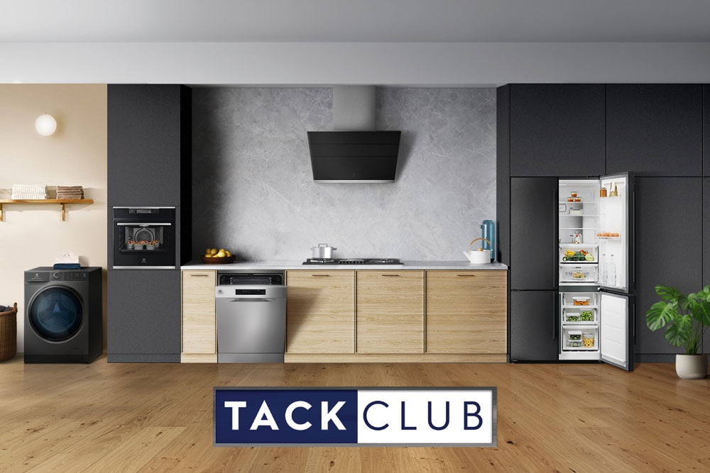 Coordinated Electrolux appliances in a modern kitchen with Tack Club logo