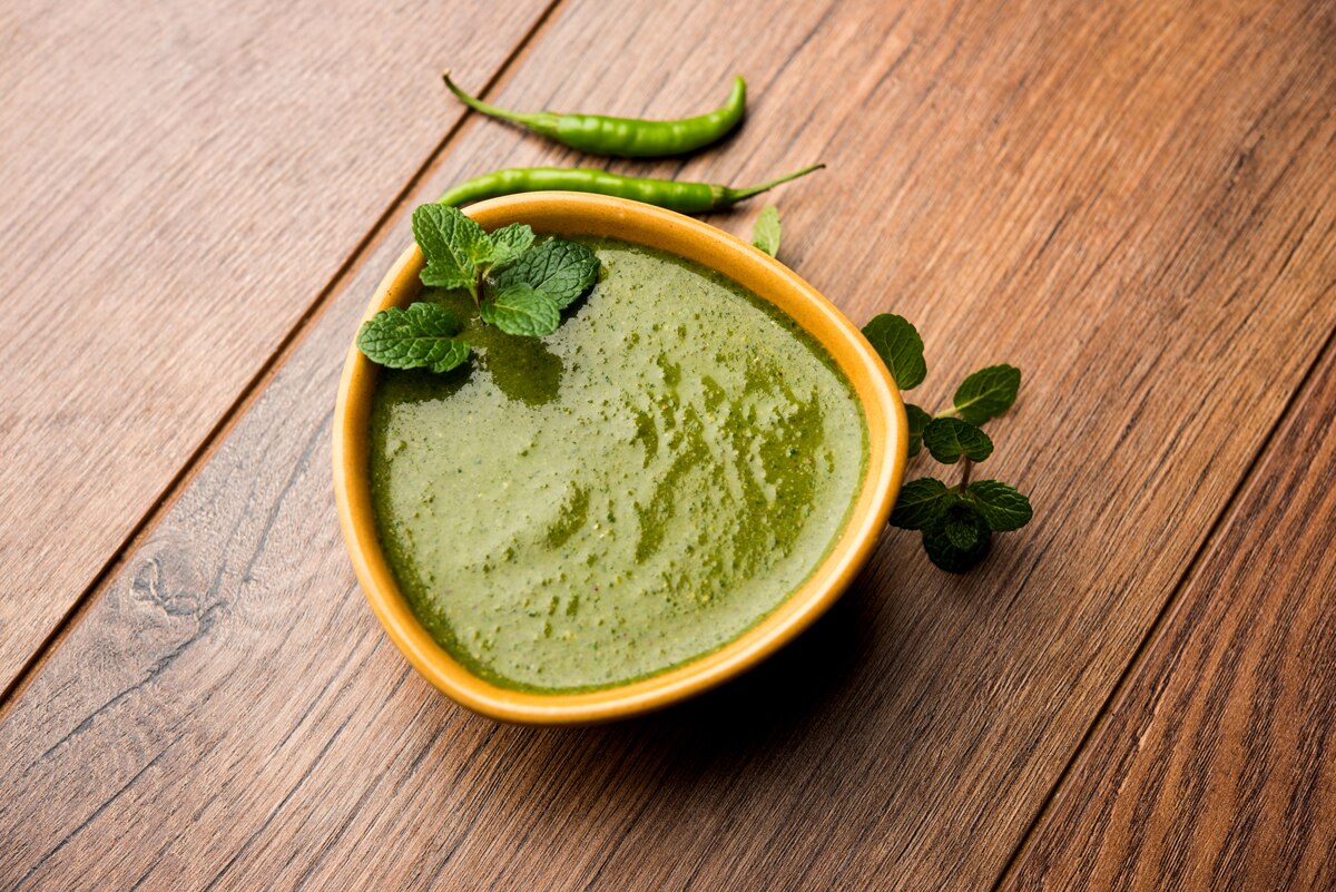 Mint chutney with fresh mint sprigs and green chilies